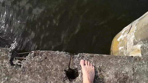 Point of view of man walking barefoot through grass field. Video stock 82392690