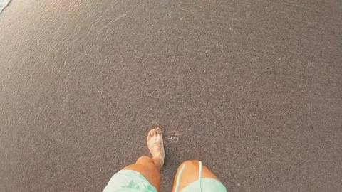Point of view of man walking on the sand at the beach enjoying and having fun Stock Footage 221877176