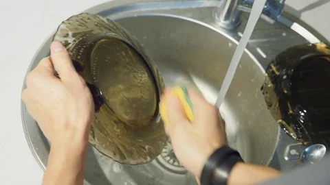 Point of view of man washing up in kitchen sink Stock Footage 82255237