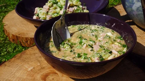 The point of view of a man who dines on the nature. Okroshka in a bowl. Seaso 스톡 동영상 101890748