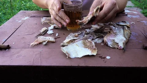 Point of view of a man who eats dried fish and drinks beer. Alcoholic concept Stock-Footage 92349053