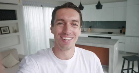 Point of view millennial man excited face live steam at home interior. Selfie Stock Footage 233993767