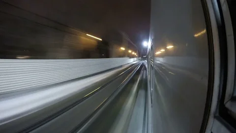 Point of view night train rushes by rail arrives and departs from platform Stockbeeldmateriaal 84234878