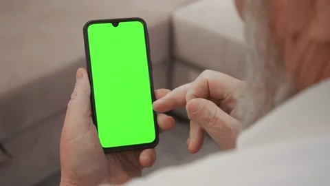 Point of View of old man Using Phone With Green Mock-up Screen Chroma Key Surfin Stock Footage 148950109