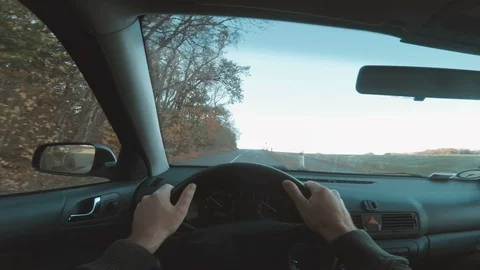 Point of view of one person driving car with hands on steering wheel Stock Footage 98063206