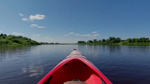 Point of view paddling red kayak on calm Daugava river in Latvia, summer travel Stock Footage 340892715