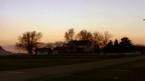 Point of view from passenger window farm house at sunset tracking from right to Stock Footage 29807472