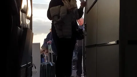 Point of view of passengers embarking on airplane from stairs Stock Footage 280794456
