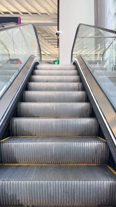 Point of view of person riding moving escalator up in modern building Stock Footage 342351042