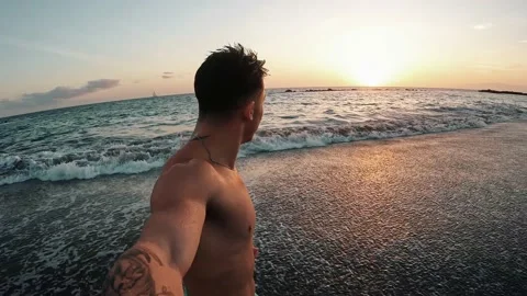 Point of view of person running and jumping to the water of an amazing beach. 動画素材 221877368