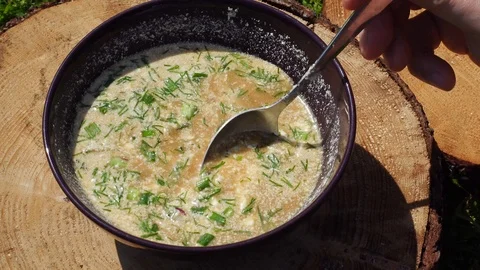 The point of view of the person who eats okroshka. Summer soup - okroshka in  Stock Footage 93155925