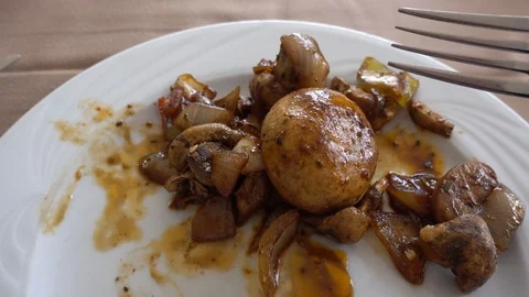 Point of view of a person who eats fried mushrooms. A man with a fork and a k 스톡 동영상 95117982