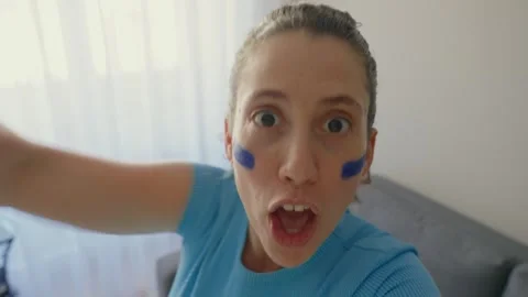 Point of view from phone or camera passionate female fan celebrates game victory Video stock 336555498