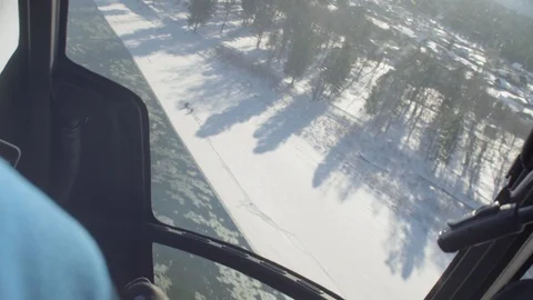 Point of view from pilot of a helicopter landing in ski touring lodge Stock Footage 102766883