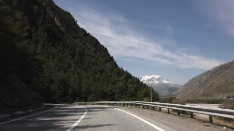 Point Of View (POV) Driving On A Mountain Road Towards Snow-Capped Peaks And A V Stock Footage 314417912