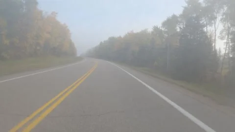Point of view, POV, from the front of a vehicle being driven along a foggy road Stock Footage 279498475