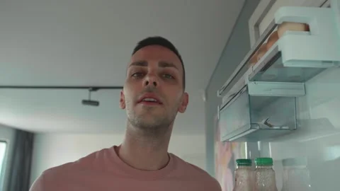 Point of view POV inside refrigerator Caucasian man smiling happy guy male open Stock Footage 241746293