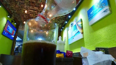 Point of view (POV) of pouring a Coca-Cola from a plastic bottle Stock Footage 328485596