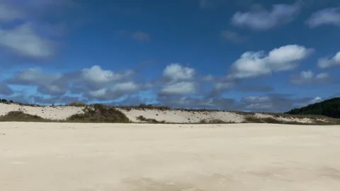 Point of view (pov) tracking shot of a sunny sandy beach Stock-Footage 241103882