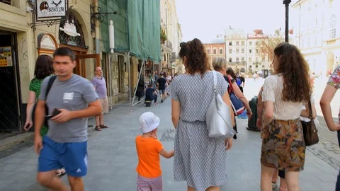 Point of view pov walking at Lviv Ukraine old town market square with people Stock Footage 112760490