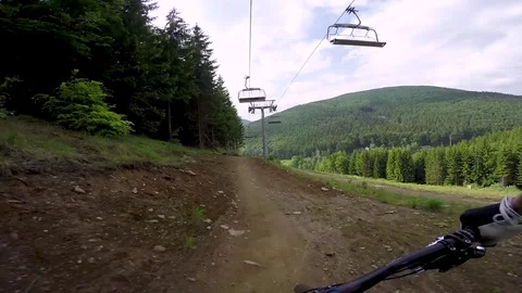 Point Of View Of Professional Mountain Biker Riding A Bike Park Trail Stock Footage 78107638