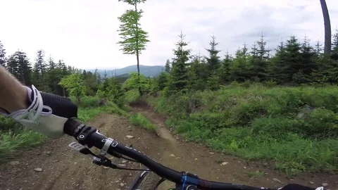 Point Of View Of Professional Mountain Biker Riding Downhill Trail At High Speed Video stock 78107862