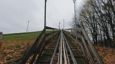 Point-of-view ride along a narrow railway track through a rural landscape on an Stock Footage 323563550