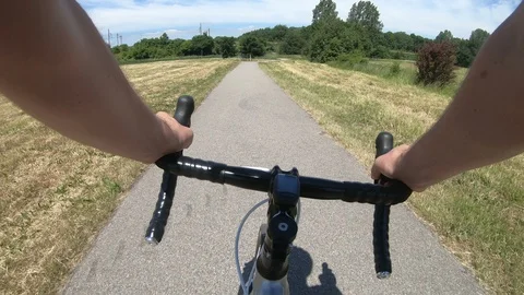 Point of view of riding a bicycle and reaching forked road Stock Footage 98229305