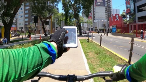 Point of view riding a bicycle distracted looking at the cell phone Stock Footage 148791226