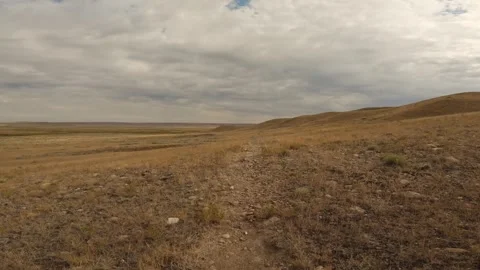 Point of view riding a mountain bike along a rough trail through dry desert Stock Footage 334945281