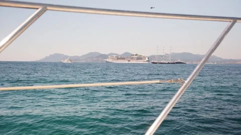 Point of view from a sailing yacht, looking through the metal railing at the 動画素材 337409826
