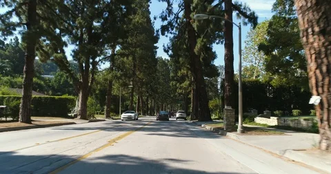 Point of view shot of Beverly dr, Los Angeles. Camera moves on street Stock Footage 85860196