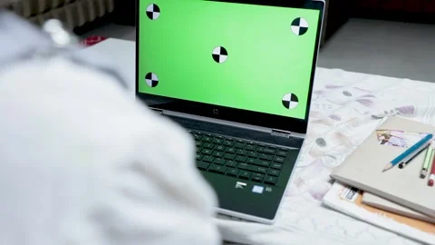 Point of view shot of Child During online classes with green screen on laptop Video stock 154100107