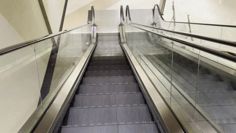 A point-of-view shot of descending an escalator, with a safety instruction Stock Footage 311791600