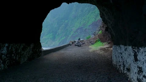 Point of view shot exiting a dark tunnel towards the ocean coast in madeira Stockbeeldmateriaal 333695302