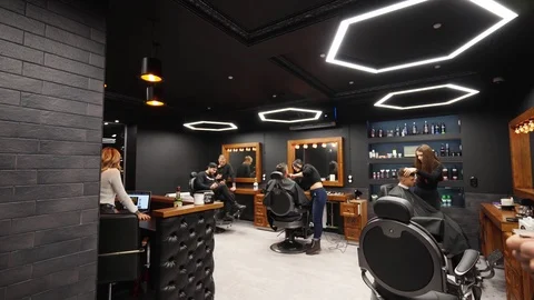 Point of view shot of hipster barber throwing a hair cloak on the client with Stock Footage 126315533