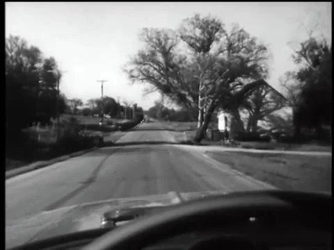 Point of view shot from inside a car driving on rural road, 1960s Stock Footage 61444852