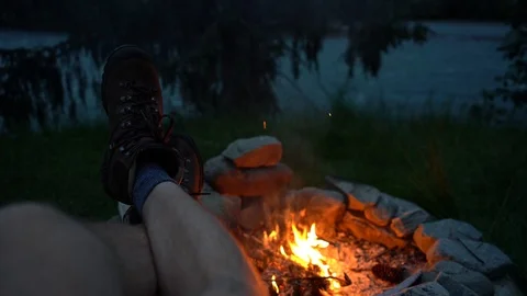 Point of view shot of a man sitting besides bonfire Vídeo Stock 114883116