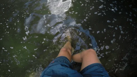 Point of view shot of man stepping into murky green water Stock Footage 90270690