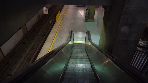 Point of view shot of a person going down an escalator to the waiting area Stock Footage 128123072