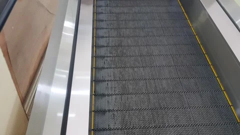 A Point Of View Shot of a person going up an escalator at mall Stock Footage 272840683