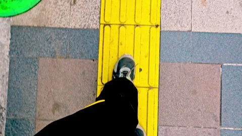 Point of view shot of a person walking forward along a bright yellow tactil.. Stock Footage 342027965