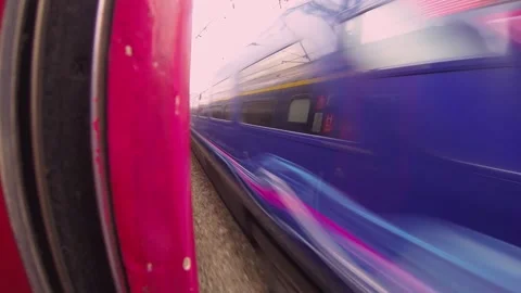 Point-of-View Shot from a red Train Window in the UK Showcasing Passing Landscap Stock Footage 297370696