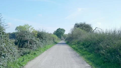 Point of view shot traveling down a secluded country path in spring Video stock 320812461
