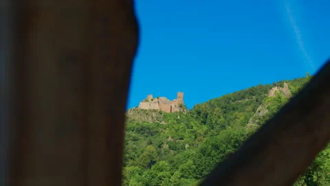 Point of view shot of two medieval castle ruins rising above forest Stock Footage 327569659