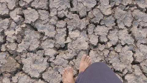 Point of view shot of a young farmer walking quickly on a drought hit field Stock Footage 150277626