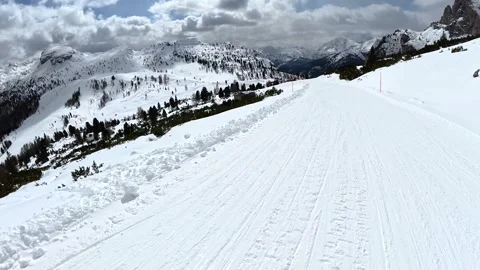 Point of view skiing down a snowy mountain slope in the dolomites Stock Footage 340624309