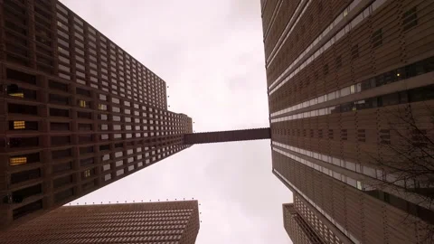 Point Of View Of Skybridge Connecting Tall Corporate Buildings In Financial Stock Footage 223360227