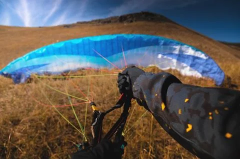 Point of view of a skydiver piloting his parachute. Hands holding the lines of Foto stock