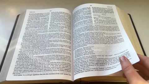 Point of view slow motion shot of reading of a thick study Bible Psalm 23 Stock-Footage 231253890